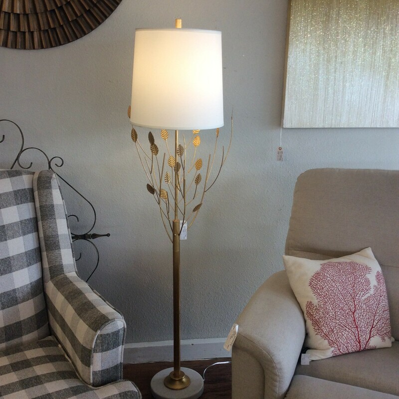 This is a lovely floor lamp! Cool and contemporary, the gold leaf branches and leaves are reaching up and just kissing the white shade.