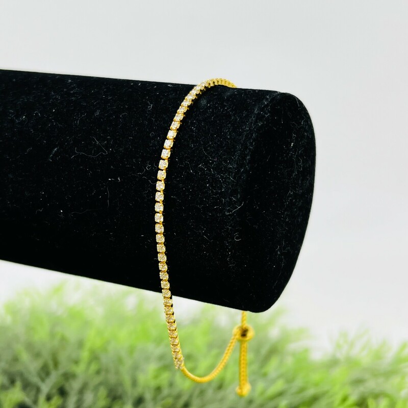 Dainty rhinestone bracelet.<br />
<br />
Such an elegant piece!<br />
<br />
Adjustable rhinestone bracelet with 14k gold over sterling metal.<br />
<br />
There is minimal wear on the bracelet.