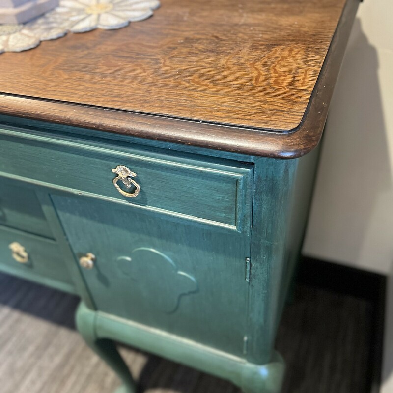 Vintage painted large buffet.

A stunning statement piece for your home!

Beautifully painted dark green Modern Victorian style large buffet with a dark wood top.

Has a large narrow top drawer.

Has two double side doors and two middle narrow drawers.

Accented with ornate gold hardware.

66in long x 39in tall x 20 1/2in deep
