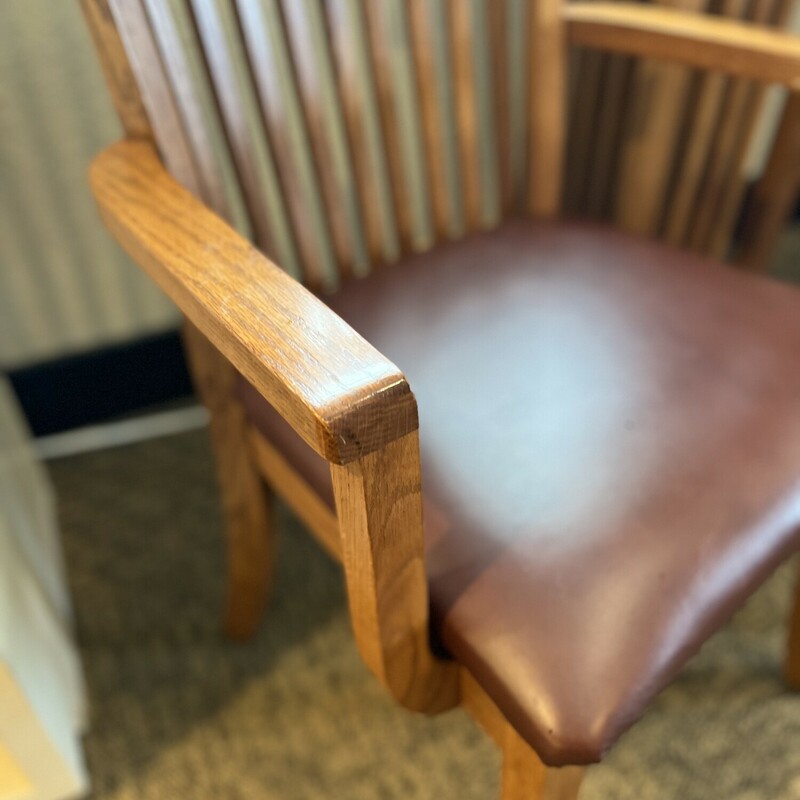 Amish made oak captain chair set.<br />
<br />
Includes 2 pieces.<br />
<br />
Beautifully hand crafted Amish made oak captain chairs with smooth brown leather cushions.<br />
<br />
There are minor scuff marks and wear on the legs.<br />
<br />
Each: 41 1/2in tall x 19in wide x 17in deep x 20in tall (seat to floor)