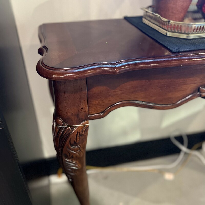 Cherry wood entry table.

Beautifully carved deep cherry wood entry table with an ornate design accent.

Has curved feet.

There is minor wear on the wood.

31in tall x 36in wide x 13 1/2in deep