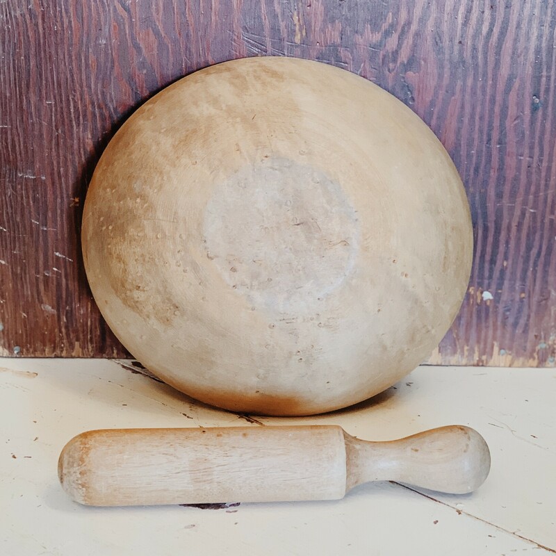 This antique wooden mortar and pestle is just amazing! A vintage or antique mortar and pestle set is breathtaking as counter decor in a kitchen. This all wooden piece would look stunning on an island, as a dining table centerpiece, on a shelf, or in a cabinet with glass doors!<br />
<br />
Measurements:<br />
Mortar: 10.5 Inches x 11.5 Inches x 3 Inches<br />
Pestle: 11 Inches x 1.75 Inches