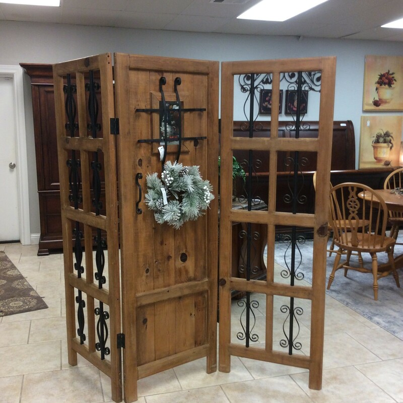 This room divider is super cool!  A creative combination of reclaimed pine and wrought iron.The middle panel actually looks like  door with a tiny peek-a-boo window. It won't be here long!
