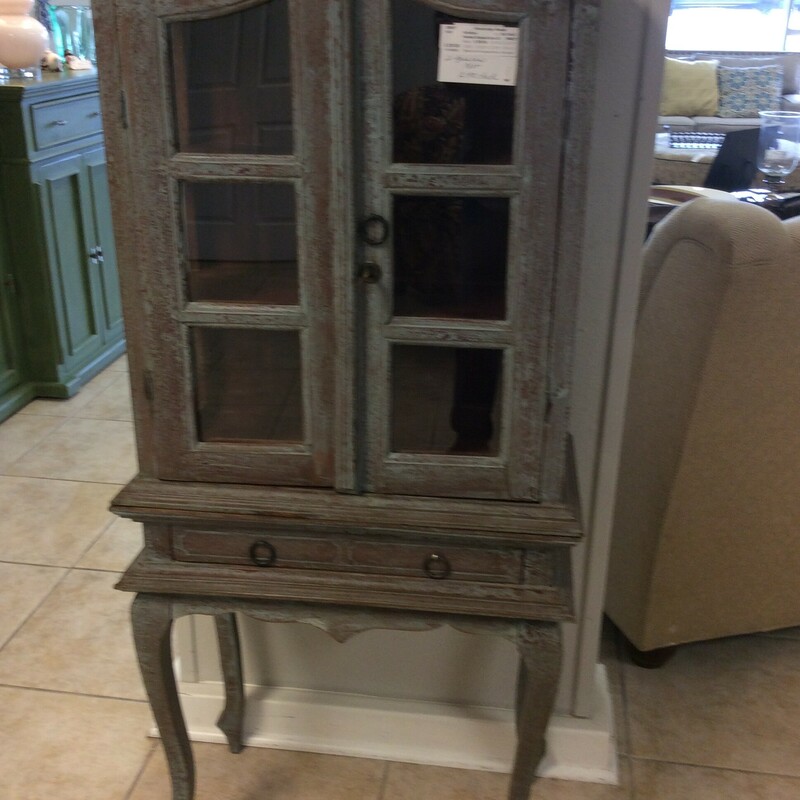 This adorable little curio cabinet has a distressed blue painted finish.