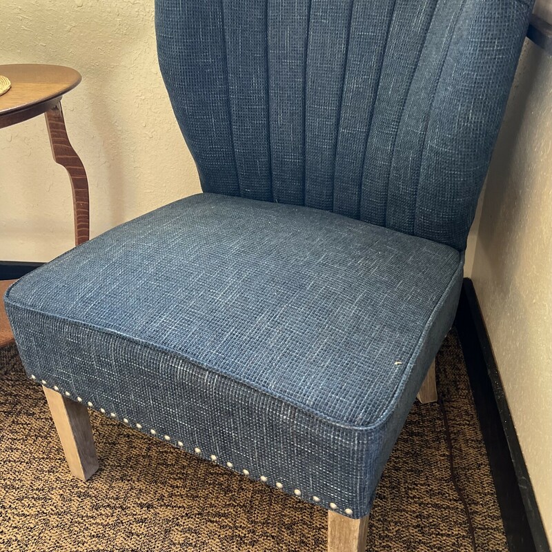 Blue tweed shell accent chair.<br />
<br />
Deep blue tweed shell accent chair with rustic wooden legs.<br />
<br />
Accented with silver nail trim.<br />
<br />
There is minor pilling on the chair.<br />
<br />
33in tall x 25in wide x 23in deep x 17in tall (seat to floor)