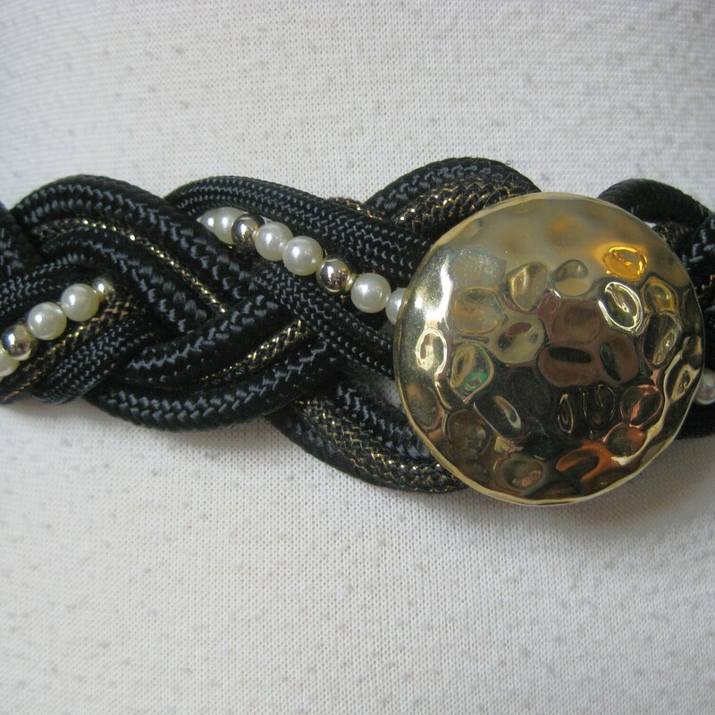 Braided Gold Statement, Black, Size: N
This iconic 80s style belt features tough braided cording, pearls and a biggish gold hammered metal central medallion.  Hooks in the back with a few option for adjustment by tying the cords in different ways.

will fit up to 33 around the body.

Thanks for looking!
#41158