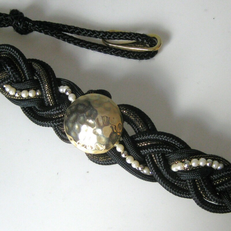 Braided Gold Statement, Black, Size: N
This iconic 80s style belt features tough braided cording, pearls and a biggish gold hammered metal central medallion.  Hooks in the back with a few option for adjustment by tying the cords in different ways.

will fit up to 33 around the body.

Thanks for looking!
#41158