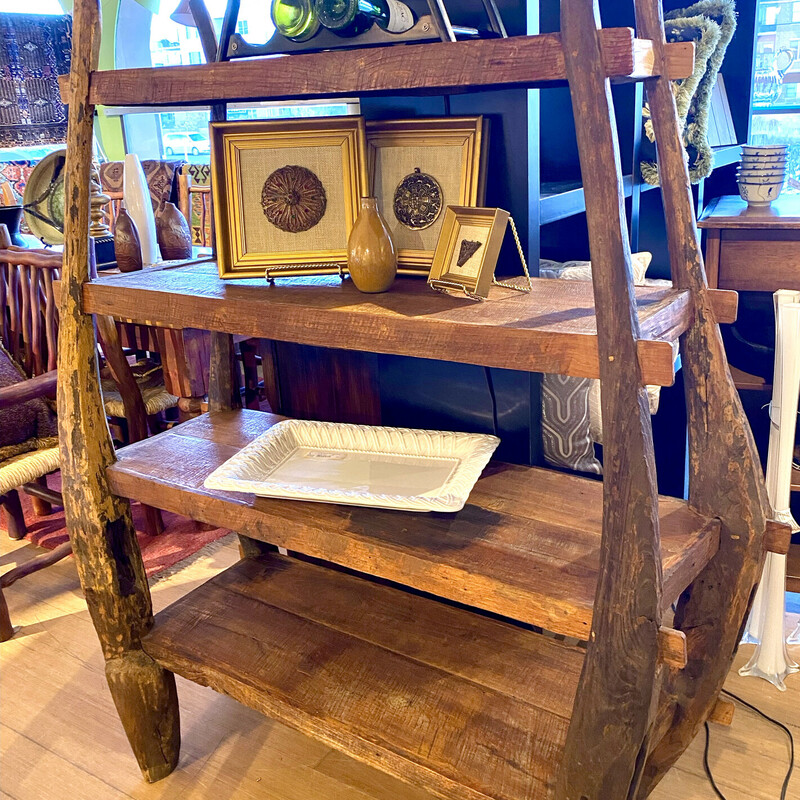 Bookshelf, 4 Shelves, Chile, Wood, Size: 51x24x65

Handcrafted and built in Chile. The uprights are four horse mule yokes and the shelves are rough hewn teak.

It is rustic and quite beautiful.