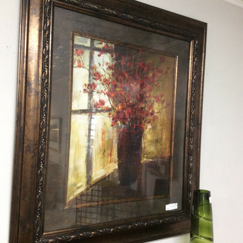 This large framed print of a vase with flowers by a window makes use of dramatic lighting to set the mood for the print.