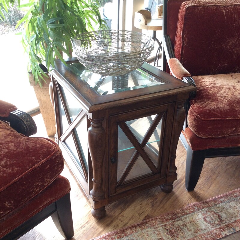 This is a beautiful oak wood and glass display end table. This table has a glass shelf and glass top.