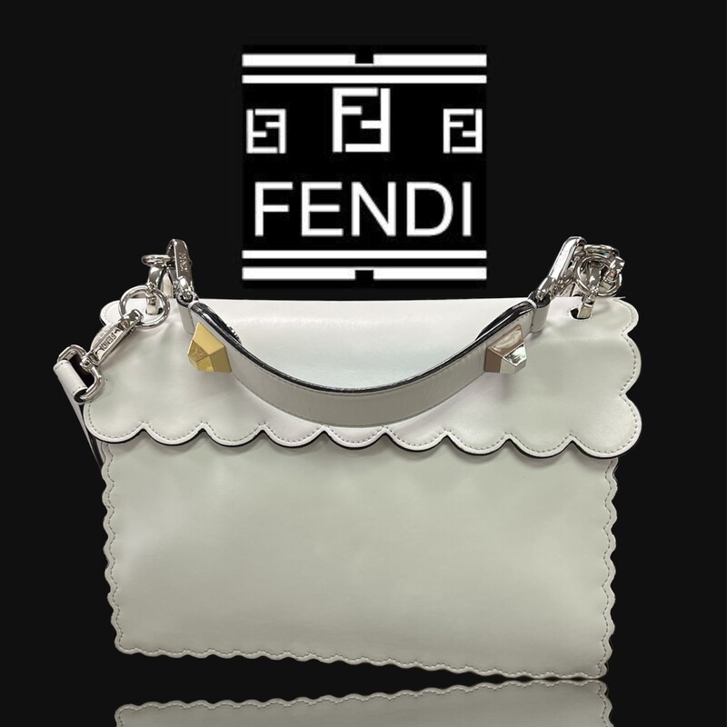 Fendi Kan I Handbag Embroidered Studded Leather Medium Handbag<br />
This authentic Fendi Kan I Handbag Embroidered Studded Leather Medium is a uniquely designed bag perfect for the stylish fashionista. Crafted from white leather, this bag features contrasting studs in the characteristic bow design, embroidered flower details, leather top handle, detachable leather strap, double stud two-tone plexiglass twist-lock closure and silver and gold-tone hardware accents. Its twist-lock closure opens to an off white microfiber-lined interior divided into two compartments and with a slip pocket perfect for storing your bare essential. Its detachable strap allows this bag to be worn longer on the body for added versatility.<br />
******Estimated Retail Price: $3,550*******<br />
Condition: Very good. A-/B+ Wear consistent with age and use.  Slight curling on front, creasing on sides, minor wear underneath flap, and in interior. Minimal scratches on hardware.<br />
Accessories: detachable strap and handle.<br />
Measurements: Handle Drop 5\", Height 7.5\", Width 10\", Depth 5\", Strap Drop 18\"<br />
Designer: Fendi<br />
Model: Kan I Handbag Embroidered Studded Leather Medium<br />
COMES WITH CERTIFICATE OF AUTHENTICITY