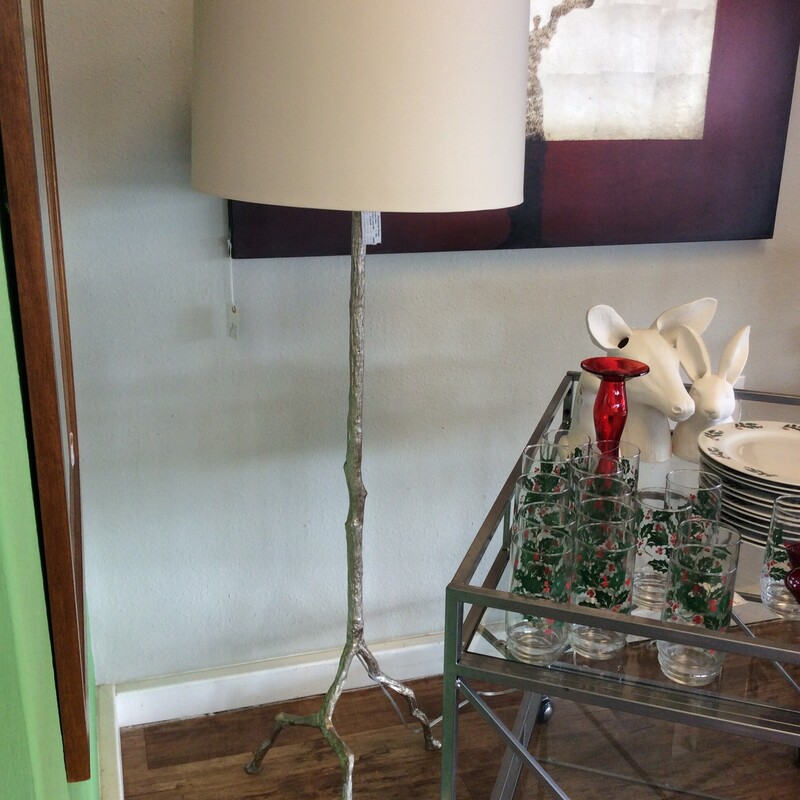 This is a very cool floor lamp! The metal base is a silvery, shimmery  tree and it's toppped off with a big, bold cream colored shade.