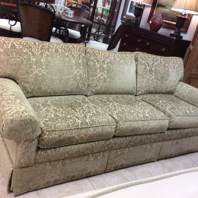 This sofa by Ethan Allen is gorgeous and is reminiscent of times past, in a good way! Upholstered in a sage green brocade on a soft champagne background, it features rolled arms and is skirted. It's in near-perfect condition. Elegant and traditional.