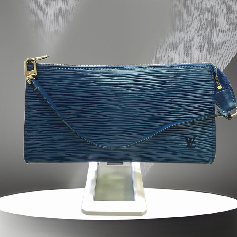 Louis Vuitton Blue Epi Leather Pochette With Logo Embossed On The Exterior, Blue Suede Lining, Gold-tone Hardware, Zipper Closure, Top Handle With A Hook (can Be Worn As A Wristlet)<br />
Comes with CERTIFICATE OF AUTHENTICITY<br />
Brand : Louis Vuitton<br />
Country Of Origin : France<br />
Type : Pochette, Pouch Epi leather<br />
Color : Blue<br />
Closure : Zipper<br />
Size Hxwxd Cm : 11.5cm x 21.5cm x 2.5cm / 4.52'' x 8.46'' x 0.98'' Width Cm : 21.5 Depth Cm : 2.5<br />
Handle Drop Cm : 14.00cm / 5.51''<br />
Serial Number : AR1915 (date: 11 of 1995)<br />
Condition : Used (very good - VINTAGE).   A few traces of usage<br />
This bag is available in similar condition on Mercari for $800.00 and vestiairecollective for $762.00