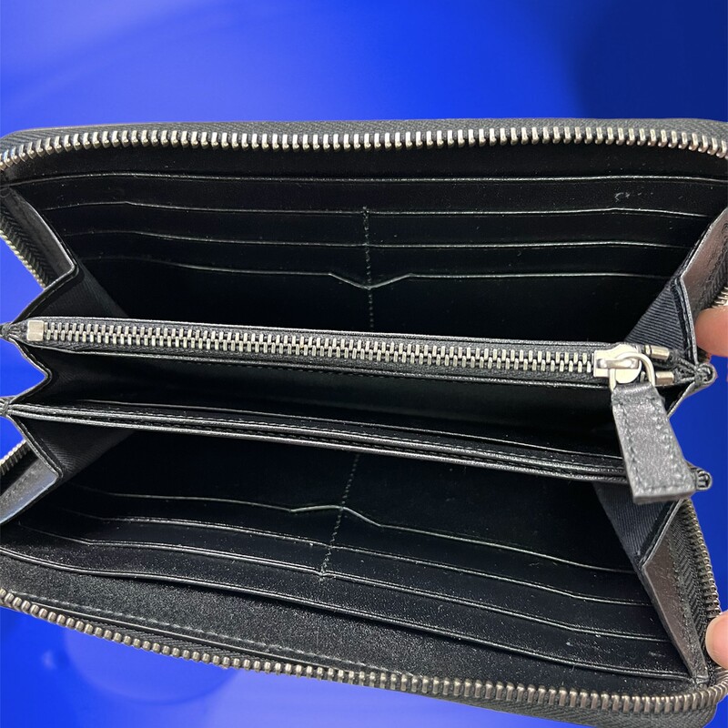 BVLGARI<br />
Bvlgari Black Leather Zip Around Wallet with silver hardware, trim leather, interior card holder pocket, leather lining, interior three compartments pocket and zipper closure.<br />
authenticity number: FG-F14-36968<br />
About the Manufacturer:<br />
Bvlgari-Greek silversmith Sotirios Voulgaris arrived in Rome in 1881 and set up his own shop there in 1884, calling it Bulgari, an Italianization of his last name (eventually spelled BVLGARI, using the classical Latin alphabet in a nod to ancient Roman culture). In 1905, he opened the company’s flagship boutique on Rome’s Via dei Condotti. Since then, BVLGARI has looked to Rome as a source of reference for its fanciful and decidedly romantic designs for necklaces, bracelets, earrings and other accessories.<br />
This wallet is in beautiful used condition, soft black leather, well cared fore.<br />
This wallet retails for $710.00 New.