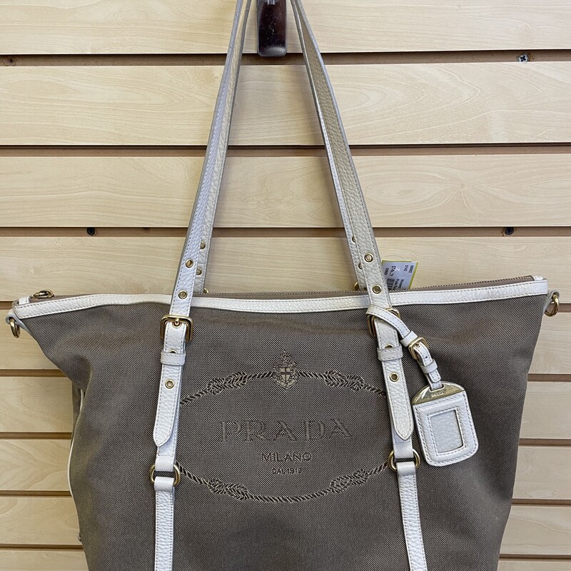 Prada Purse, Khaki Fabric with Cream Accents, Gold hardware and Picture Keychain, Prada Logo on Front, 1 Large Zippered Pocket and 1 Small Pocket Inside, Size: 11 1/2 x 6 x 14  Inches

*Additional shipping and insurance rates will apply. A separate invoice will be sent due to the value of this item.