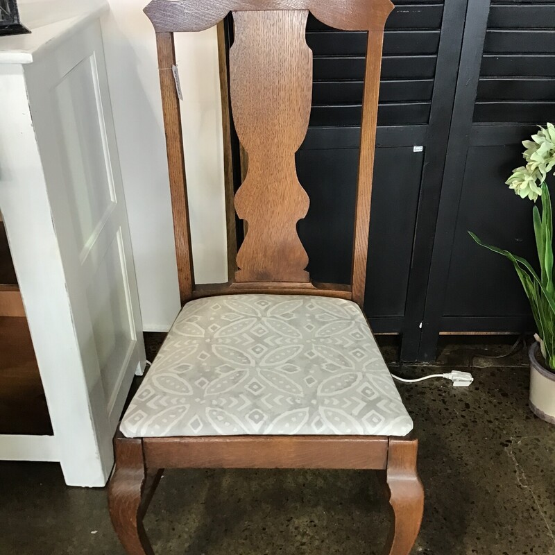 This vintage oak chair has been updated with new foam and a gray/cream upholstery.