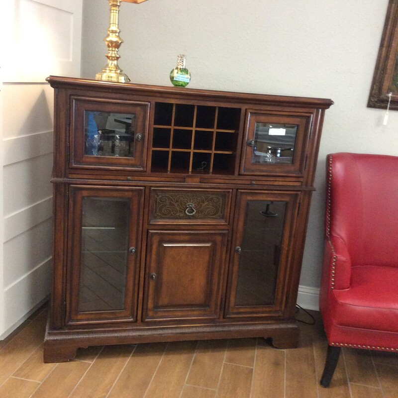This is a beautiful cherry wood wine/bar cabinet. This cabinet has 5 cabinets, 1 drawer and a slotted section for wine bottles.