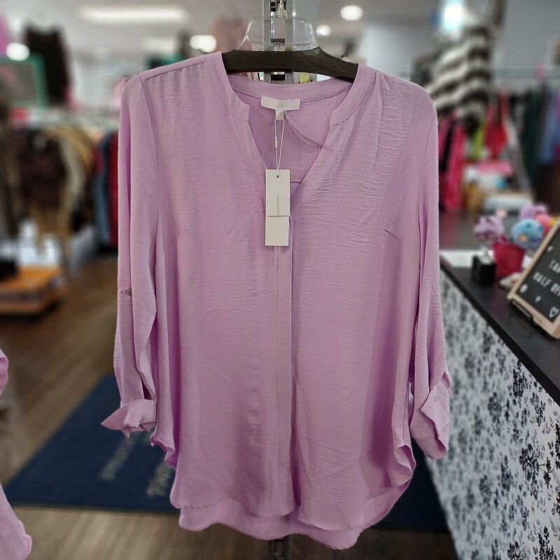 Perfect spring blouse in lavender with a hidden button up front and no collar. This blouse can be worn as long or half sleeve. Has a tab/button feature for the sleeves. Brand new with tags by Adyson Parker!