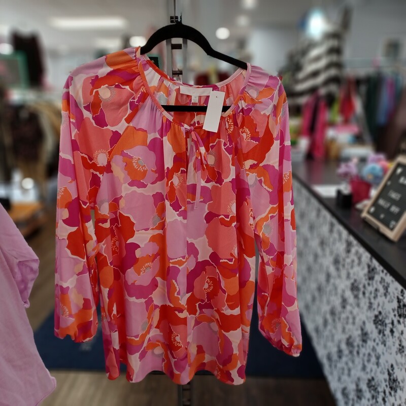 Loving this beautiful floral designed blouse in pinks and orange. Perfect for spring and summer. A little tie at the neckline and elastic cuffed sleeves make this super easy to dress up or down. Brand new with tags by Adyson Parker