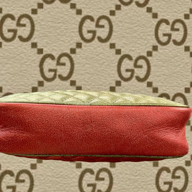 GUCCI<br />
Laminated Nappa Trapuntata Mini Zumi Dome Shoulder Bag<br />
Description:<br />
Gucci Shoulder Bag<br />
Metallic & Red Leather<br />
Colorblock Pattern<br />
Gold-Tone Hardware<br />
Single Shoulder Strap<br />
Poplin Lining<br />
Zip Closure at Top<br />
Shoulder Strap Drop: 25\"<br />
(Adjustable strap, can be worn as a shoulder or crossbody bag)<br />
Height: 5\"<br />
Width: 6.75\"<br />
Depth: 1.5\"<br />
Comes with CERTIFICATE OF AUTHENTICITY<br />
\"The Real Real\" has this bag for $895.00 in similar condition.<br />
This bag is in like New Condition.