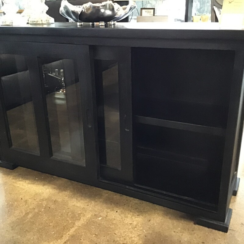 Brand New!
Sierra Living Concepts
Online for $1,549.00 (reg. $2,899.00)
Sleek, simple and sophisticated, this Bremond Solid Rosewood 100% Handcrafted Sliding Glass Door Rustic Buffet is definitely one of a kind. Featuring a plain design and a unique dark espresso finish, this sideboard has an understated industrial appeal that is emphasized by its sliding-door aesthetic. The simplicity of its design is one of its most attractive qualities. The top frame is lightly extended, while the bottom is complemented by low-height, platform style, oversized square-ish feet. The middle features glass-paned sliding doors with recessed wood handles on either side for better leverage. These doors slide away to reveal 2 open shelves for better organization.

Dimensions:  42x13x25