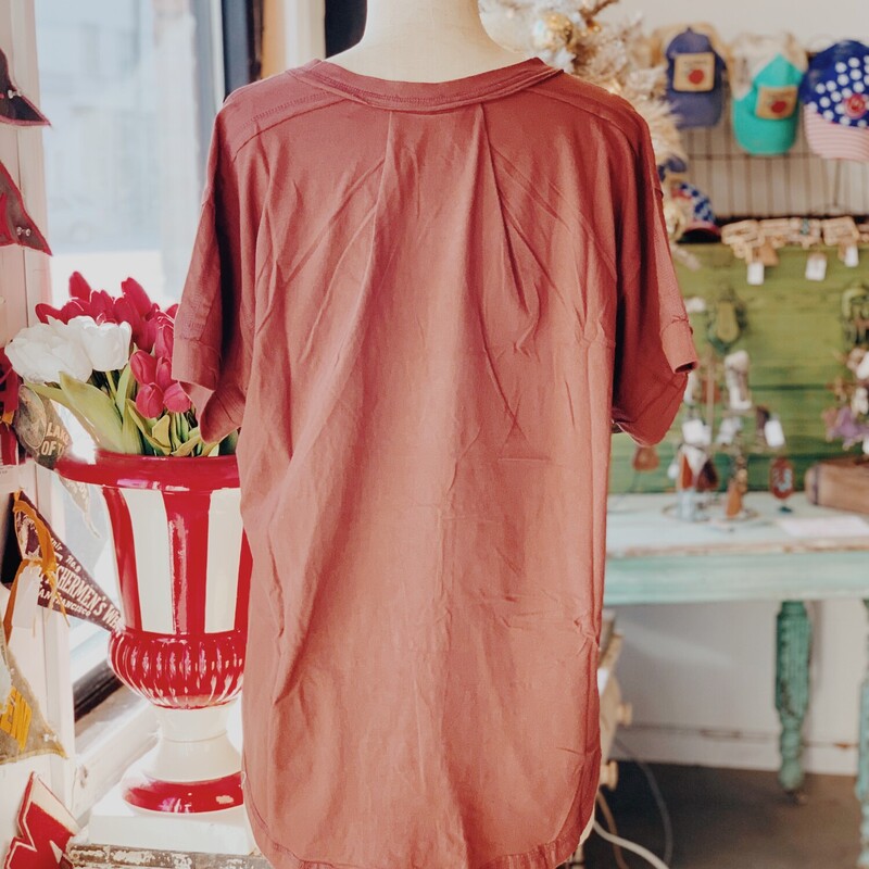 This top is an adorable step up from your average t-shirt! The buttons on these shirts are only on one side to give a relaxed and flowy look!