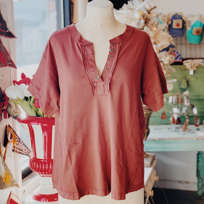 This top is an adorable step up from your average t-shirt! The buttons on these shirts are only on one side to give a relaxed and flowy look!