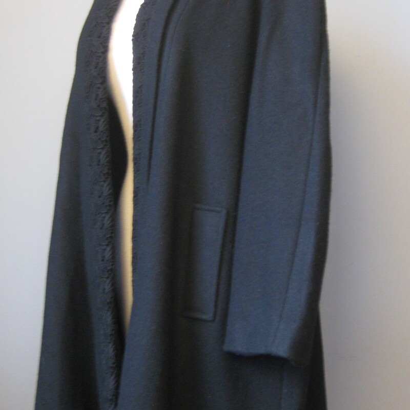 Vtg 40s Wool Evening Coat, Black, Size: Medium<br />
<br />
Dramatic  coat in black wool with a swing silhouette<br />
This coat is heavy and warm but it's designed to be worn in the evening, slipped on and off by your escort, servant or yourself.<br />
It has no closures.<br />
The front edge is trimmed with gorgeous black floral braiding.<br />
Side pockets<br />
<br />
Fully lined in black with a label that seems a lot later than the style and the construction of the coat indicate.  It could actually be from the 70s!<br />
It has built in shoulder pads, not large, there more to support the weight of the coat than to exaggerate the shoulder line.<br />
<br />
It should fit a large to an extra large<br />
<br />
Flat measurements, taken on the INSIDE of the coat, please double where appropriate:<br />
<br />
Armpit to armpit: 27<br />
waist and hips free<br />
Overall Length: 40.25<br />
<br />
Excellent condition!<br />
<br />
Thanks for looking!<br />
#541029