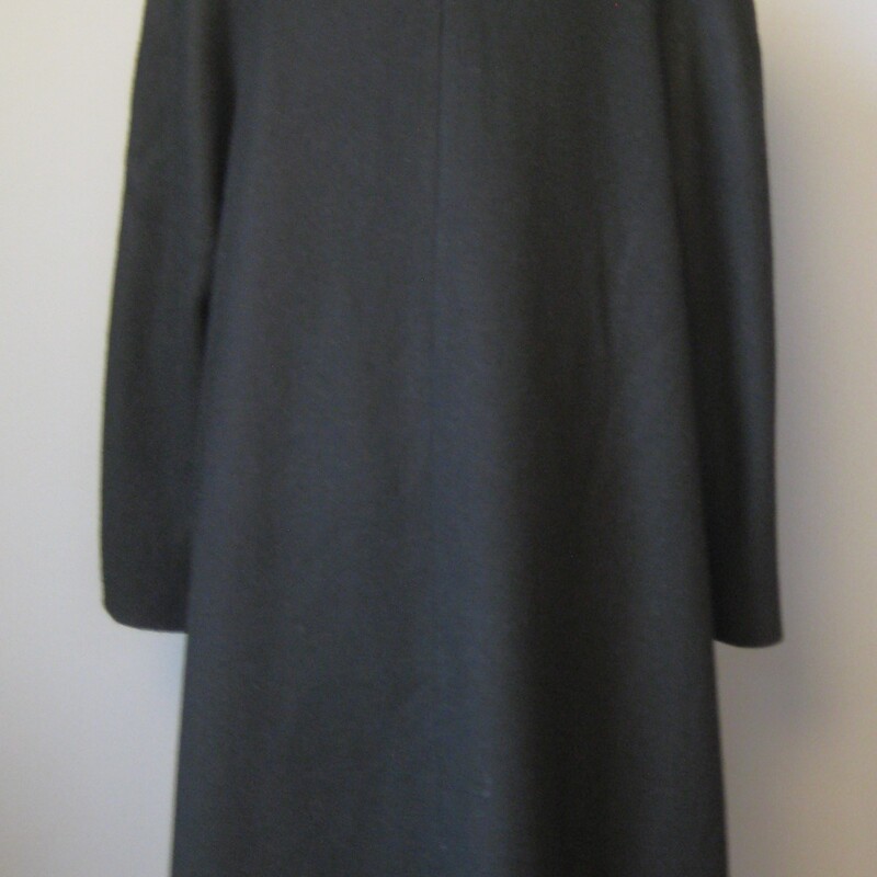 Vtg 40s Wool Evening Coat, Black, Size: Medium<br />
<br />
Dramatic  coat in black wool with a swing silhouette<br />
This coat is heavy and warm but it's designed to be worn in the evening, slipped on and off by your escort, servant or yourself.<br />
It has no closures.<br />
The front edge is trimmed with gorgeous black floral braiding.<br />
Side pockets<br />
<br />
Fully lined in black with a label that seems a lot later than the style and the construction of the coat indicate.  It could actually be from the 70s!<br />
It has built in shoulder pads, not large, there more to support the weight of the coat than to exaggerate the shoulder line.<br />
<br />
It should fit a large to an extra large<br />
<br />
Flat measurements, taken on the INSIDE of the coat, please double where appropriate:<br />
<br />
Armpit to armpit: 27<br />
waist and hips free<br />
Overall Length: 40.25<br />
<br />
Excellent condition!<br />
<br />
Thanks for looking!<br />
#541029