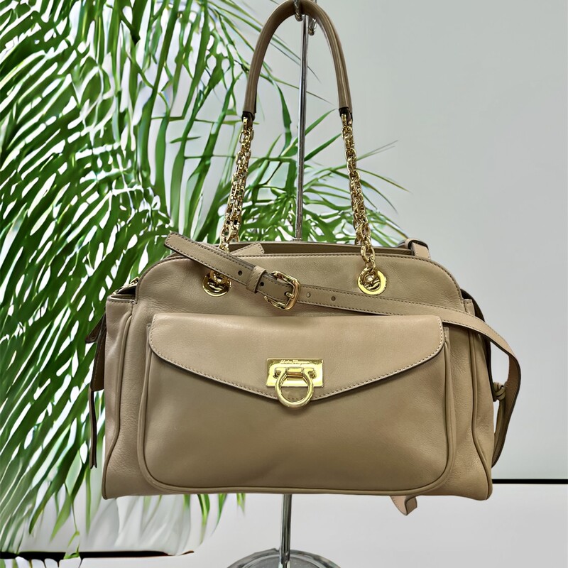 FERRAGAMO
Gancini Pocket Chain Bowler Bag Leather Medium

Designer: Salvatore Ferragamo
Dimensions: Height: 9.5 in (24.13 cm)Width: 13 in (33.02 cm)Depth: 5 in (12.7 cm)
Period: 21st Century
Material Notes:
Exterior Material: Leather Exterior Color: Beige
Interior Material: Fabric Interior Color: Beige
COMES WITH CERTIFICATE OF AUTHENTICITY

About the Designer:
Salvatore Ferragamo Clothing
A perfectionist who as a child crafted a pair of white shoes for his sister’s first holy communion because his parents couldn’t afford new footwear, Salvatore Ferragamo was ambitious from his earliest days. The young Italian shoemaker established in the years that followed what would one day become a fashion empire — the highly profitable multinational family-owned and -operated luxury brand today counts more than 600 stores in 96 countries around the world, and vintage Salvatore Ferragamo shoes, belts, handbags and other clothing and accessories are objects of desire for fashion lovers everywhere.

Salvatore Ferragamo sought an education in the art of shoemaking when he was eleven — he apprenticed with a local shoemaker and spent a short time in nearby Naples learning what he could at a shoe factory. He opened his first shop with a handful of workers the following year, and in 1914 — when he was still a teenager — Ferragamo emigrated to America, just as his siblings had before him, seeking new opportunities for work and to learn in the footwear trade.

After securing a job at the Plant Shoe Factory in Boston, Massachusetts, Ferragamo was uninspired by machine-made footwear. He moved across the country to Santa Barbara, California. Owing to a connection he made with a then-actor cousin, Ferragamo found work with the American Film Manufacturing Company. He made women’s shoes and provided durable cowboy boots for a film crew’s costuming department. Ferragamo’s reputation in the world of Hollywood cinema soon broadened, and he established a storefront in Mission Canyon where he made shoes by hand for the likes of actresses Gloria Swanson, Greta Garbo and Dolores del Río.

By the 1920s, film directors commissioned Ferragamo to produce shoes for a range of movies — the list of films eventually included The Ten Commandments, The Covered Wagon and The Thief of Baghdad. When he felt comfortable enough with the English language, Ferragamo also enrolled in anatomy courses at the University of Southern California in Los Angeles in order to better understand motion and the demands that we place on our footwear.

By the late 1920s, Ferragamo sought to expand production of his shoes and returned to Italy. He hired scores of apprentices to work in a factory in Florence, where Ferragamo carefully melded the principles of handcraftsmanship with all that he learned about America’s shoe factories. He filed patents — hundreds over the years — on the steel shank arch and many other unique aspects of his shoe design, and when economic and political influences during the 1930s forced Ferragamo to substitute pressed cork for steel to support the arch, the wedge heel was born. Other creative materials he integrated into his forward-looking creations were hemp, felt, nylon fishing line, fish skin and cellophane twisted with silk.

In the late 1940s, the brand’s first storefront opened in Manhattan, and today Salvatore Ferragamo is known worldwide and is synonymous with a wealth of iconic footwear such as Viva ballet flats, Vara Bow pumps, Gancini loafers and lots more. Ferragamo’s son, Ferruccio, was appointed CEO in 1984. Under his leadership, Ferruccio diversified and expanded the fashion business further, getting into sunglasses, fragrance, watches and made-to-measure men’s shoes. Ferruccio was succeeded by his brother, Leonardo Ferragamo, and British designer Maximilian Davis is now creative director of the brand.