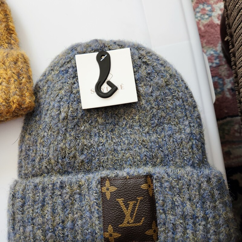 THIS IS A BRAND NEW HAT I HAVE  EMBELLISHED.
I USE  DESIGNER NOTIONS, OR PIECES FROM A SWEATERS I CUT IN DIFFERENT SHAPES.   I ALSO USE DESIGNER SCARVES PIECES, PATCHES FROM GARMENT BAGS THAT I HAVE DECONSTRUCTED.  THE CC BUTTONS ARE FROM A 2007 CASHMERE SWEATER THAT WAS BEYOND REPAIR.
THEY ARE SEWN ON BY ME
TWEED RIVER FARM PITTSFIELD VT
I DO GUARANTEE MY WORK 100%
ONE OF A KIND
ONE SIZE
GREENBLUE HEATHER