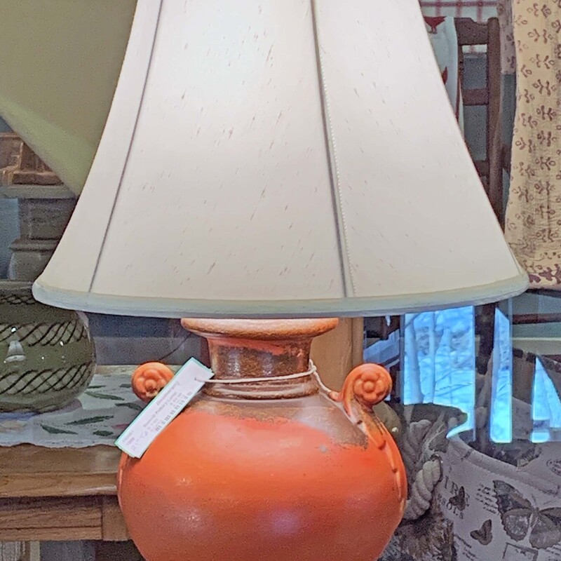 Rumrill Pottery Lamp
 Size: 22 Tall
Vintage orange pottery lamp with side decoration.  Great accent piece!