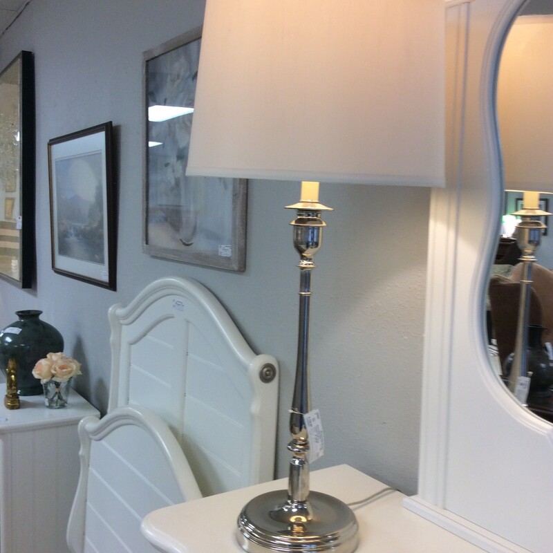 This candle stick style lamp has a polished chrome finish.