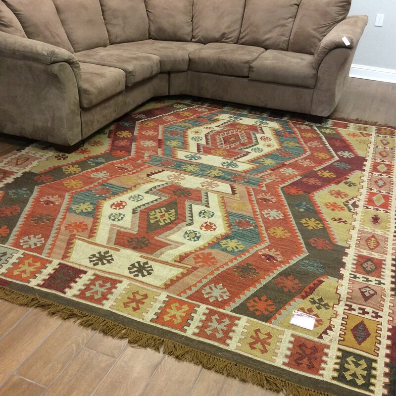 This Pottery Barn Dhurrie rug is woven in earth tones with a tribal pattern.