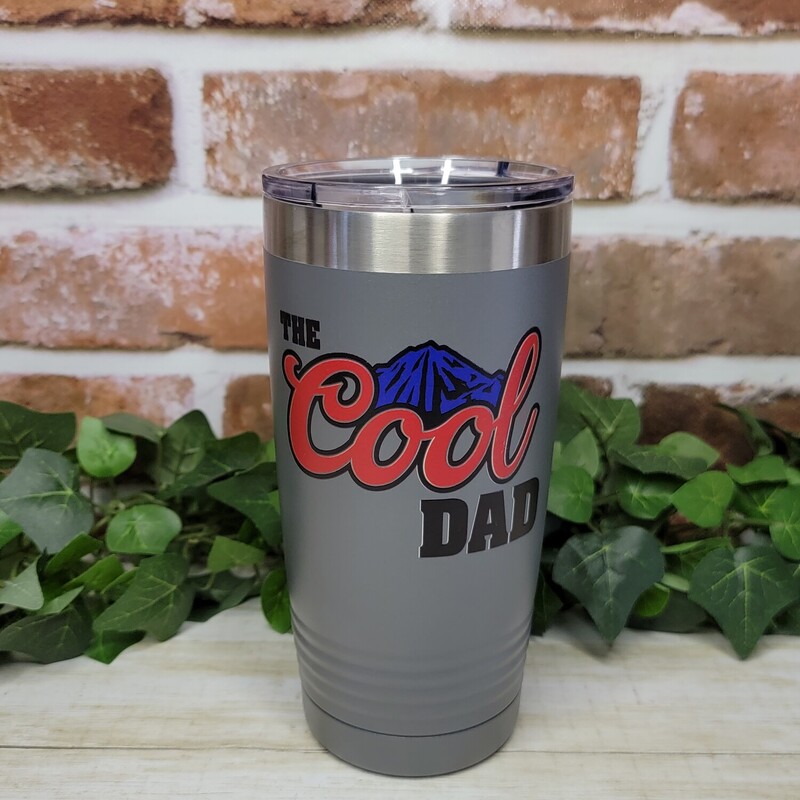 Dad will love his new custom tumbler. Our tumblers are UV Printed with the image shown of the Cool Dad with blue mountains.

Our Tumblers are powder coated and stainless steel; double wall vacuum insulated. Keep your drinks ice cold longer and it is great for hot beverages. The clear lid even allows for use of straws!- Double wall 18/8 stainless steel construction

- Features copper insulation that keeps drinks HOT for 8 hours and COLD for 16 hours
- Tapered design that easily fits in cup holders
- Clear push-on lid
- No sweat Exterior
- Hand wash recommended

We UV Print the cups; so there is no worries of a vinyl decal peeling or coming off.