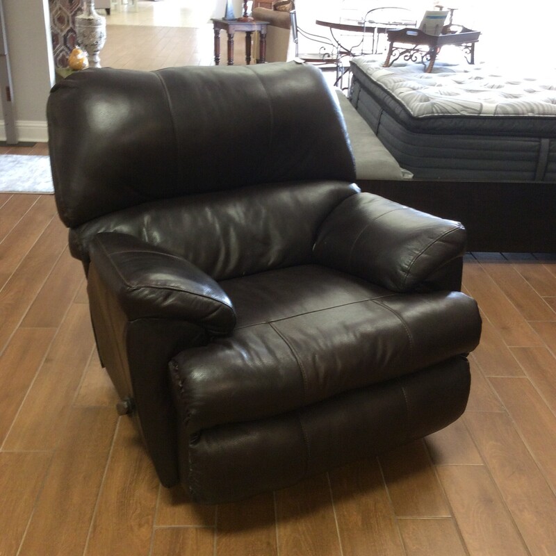 This recliner has been priced to move! Over-sized and over-stuffed, it has been upholstered in a very dark brown leather with topstitching. We have 2 of them.