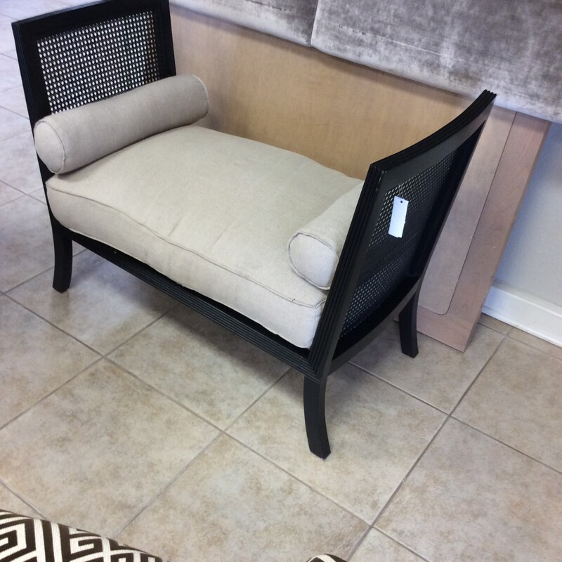 This stylish little bench has caned side panels in a black painted finish with a linen covered cushion and two bolster pillows.