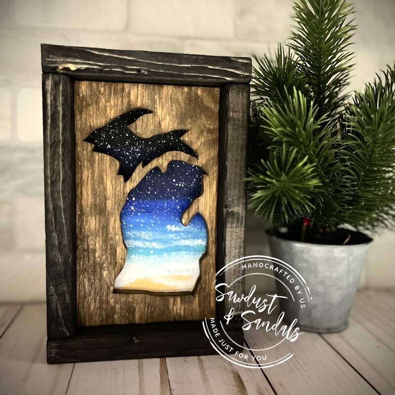 Hand cut Michigan state from aged wood; overlaying a hand painted nature scene and Framed in a black stain.  8.5' x 5.5'  Created by a local artist  Each piece is unique and no 2 are the same.
