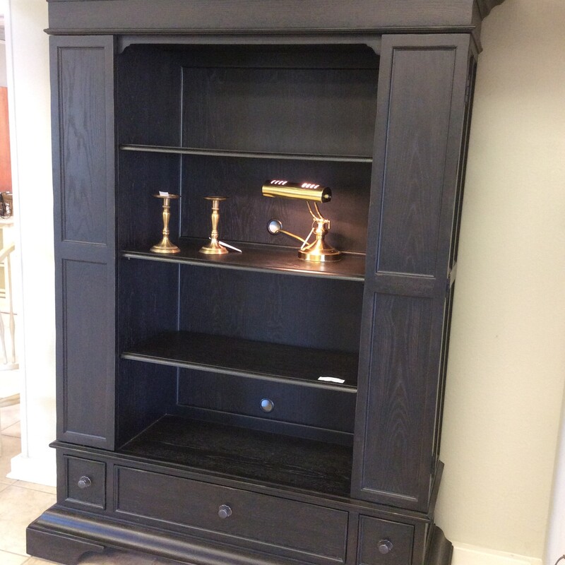This bookcase by Bernhardt has a black painted finish with side panels that open for extra storage.