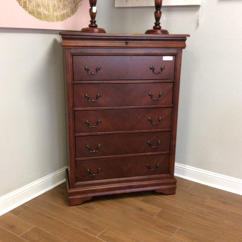 This is a beautiful dark wood, 5 drawer chest. This chest has a top drawer for small items such as jewlery. It is made by Klaussner Home Furnishings.