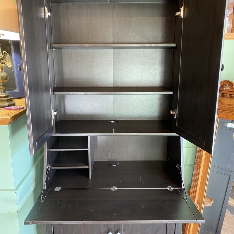 Black Wooden Storage Cabinet
2 Shelves on Top with 2 smaller shelves, and 2 shelves on bottom. Has flip down front for extra space


78H, 35W, 18D