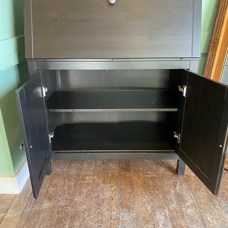 Black Wooden Storage Cabinet
2 Shelves on Top with 2 smaller shelves, and 2 shelves on bottom. Has flip down front for extra space


78H, 35W, 18D