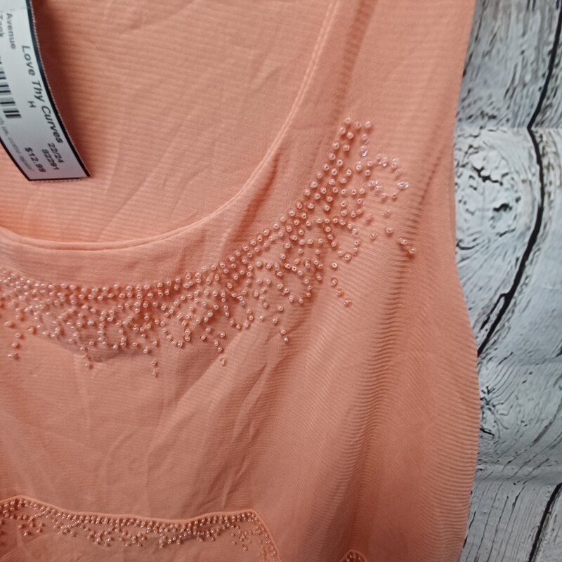Peach colored tank with beading across the front