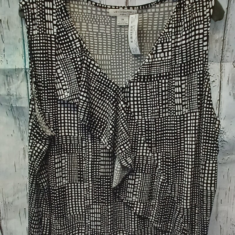 Sleeveless blouse in black and white with a ruffle crosswise on the front.