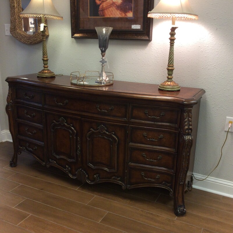 This beautiful buffet/dresser is traditional in style and will remind you of a simpler time. It features lovely carved details, lots of drawer space and vintagy hardware.This would be a beautiful addition to any home!