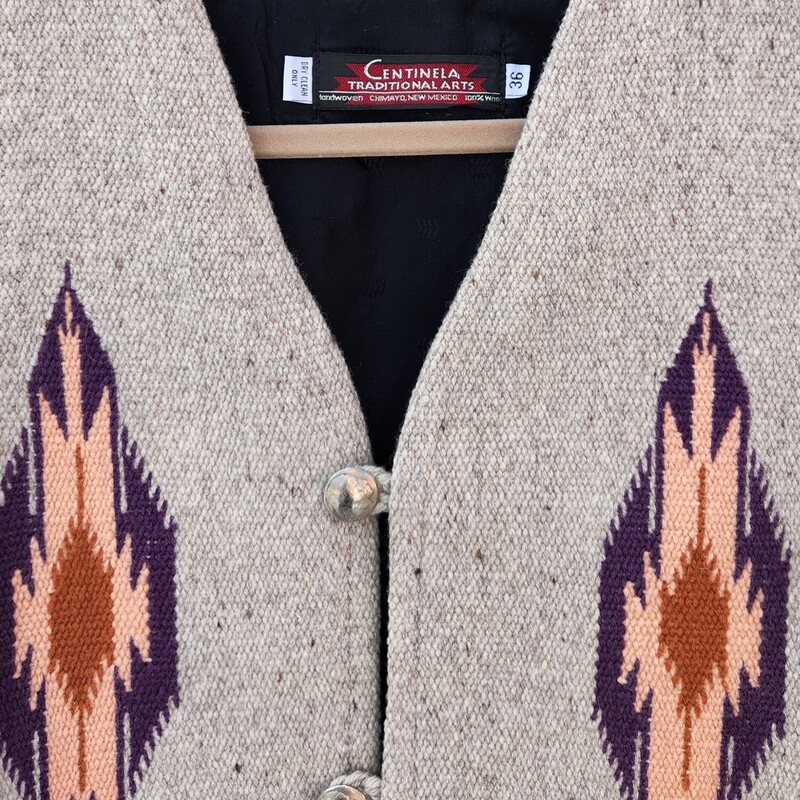 Vintage Centinela Traditional Arts Hand-woven Wool Vest size 36<br />
This style of vest has been done for many years in Chimayo. This Vest was hand-woven. It consists of some variation of Chimayo designs on front and back panels. Beige Wool with pink, purple and coral included in its design. Three 1 inch pewter buttons.  Size is missing but it is the size of a 36.<br />
Pit to Pit 19 inches across<br />
Waist 19 inches across<br />
Down the back 20 inches<br />
EUC<br />
Retail $360