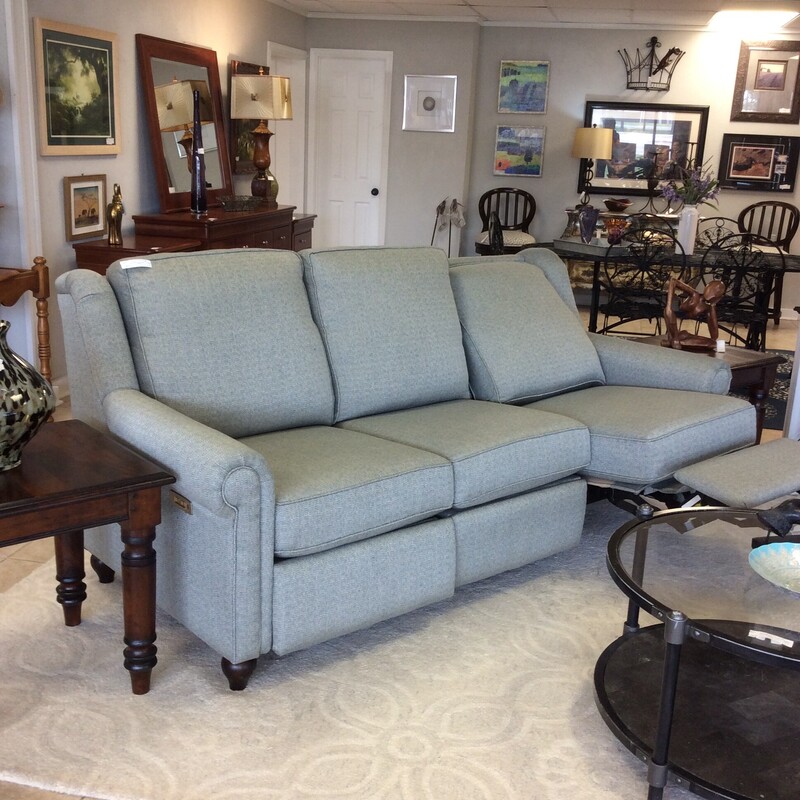 This reclining sofa from Bassett Furniture is upholstered in a gray/green tweed material and has dual recliners.
