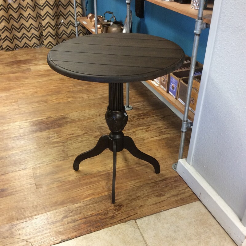 This is a beautiful Uttermost Pedestal Table. This table is dark wood and has a rustic feel to it.