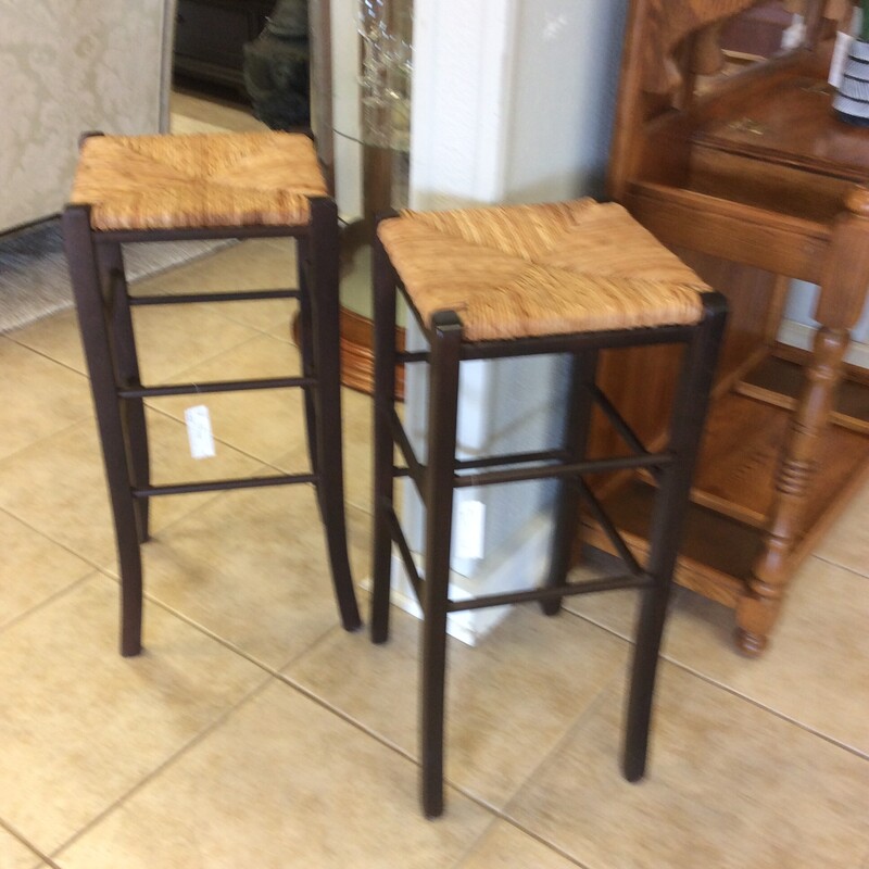 This pair of barstool have rush seats with a dark stained wood frames.
